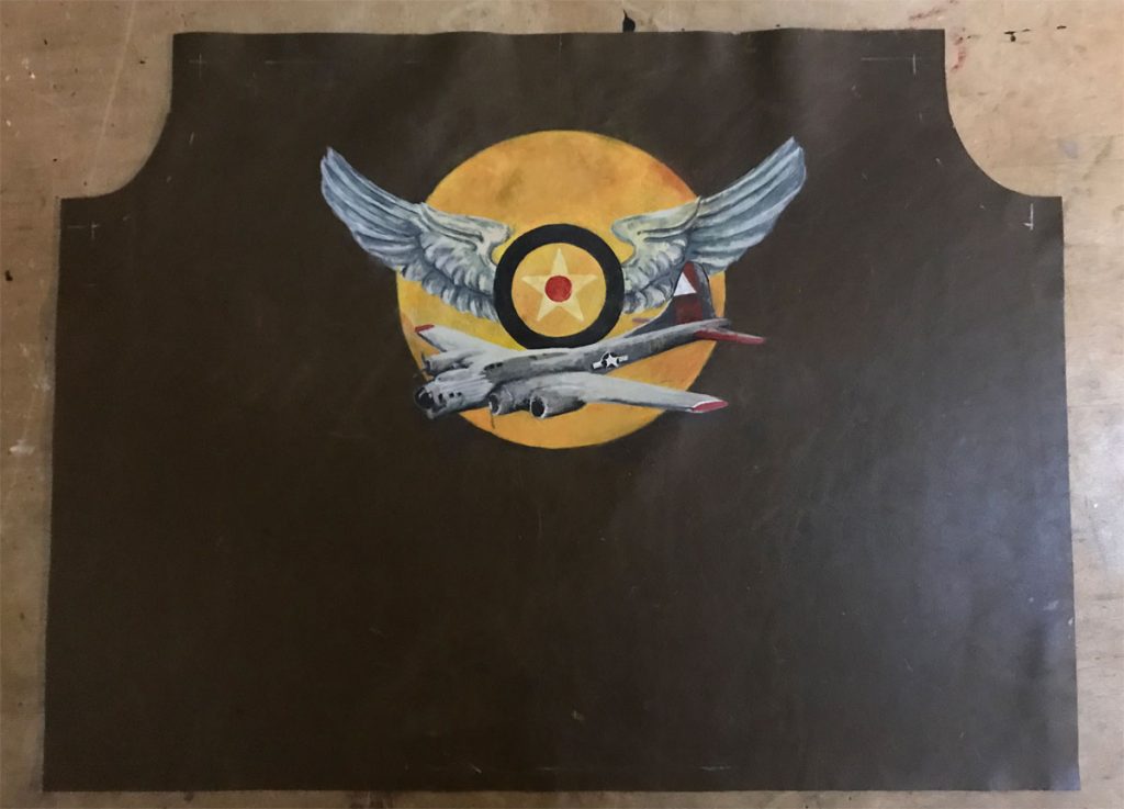 Wing and airplane graphic painted on jacket back just prior to jacket assembly