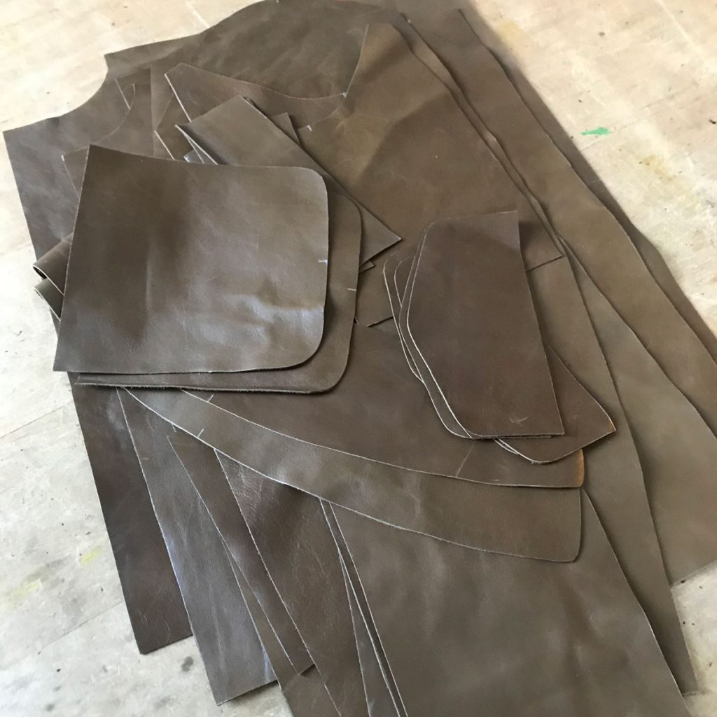 A jacket’s worth of pieces cut from 2.5oz cowhide and stacked on the worktable