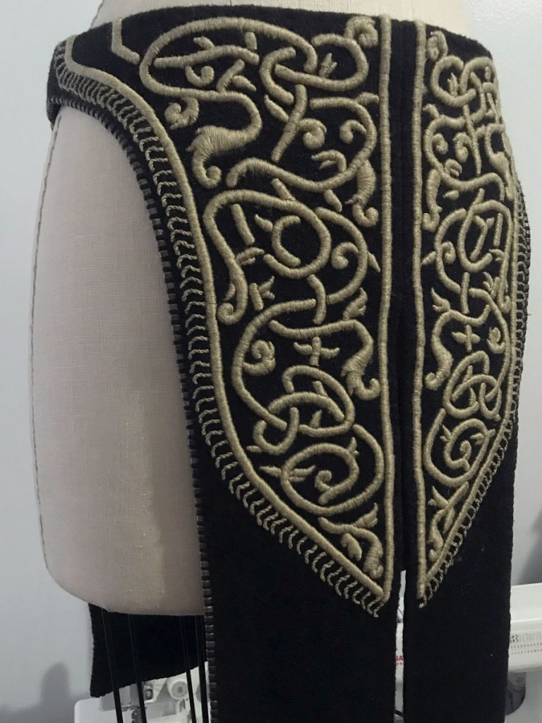 Finished embroidered skirt panels displayed on dress form