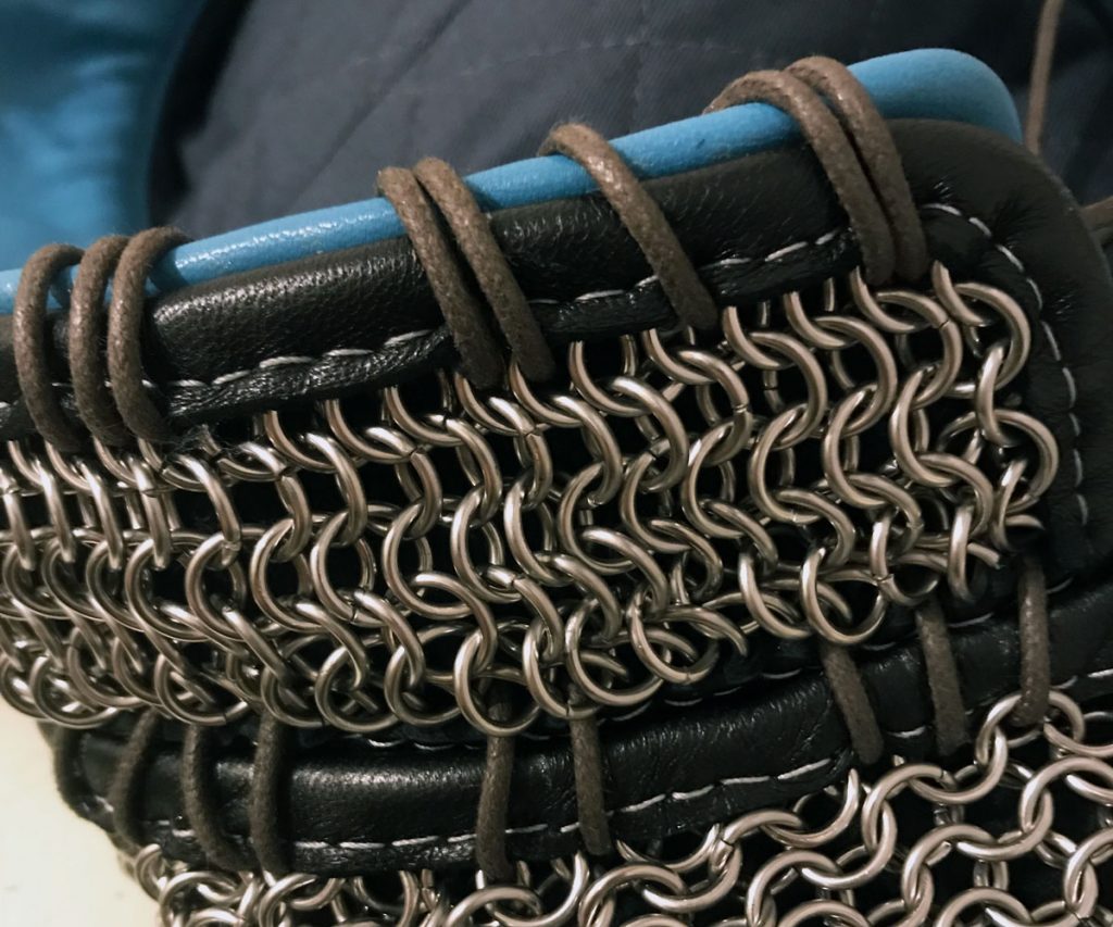 Blue leather and chainmail vests laced together with cotton cord around the edges