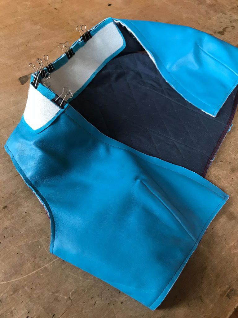 Collar pinned to partially complete vest with binder clips